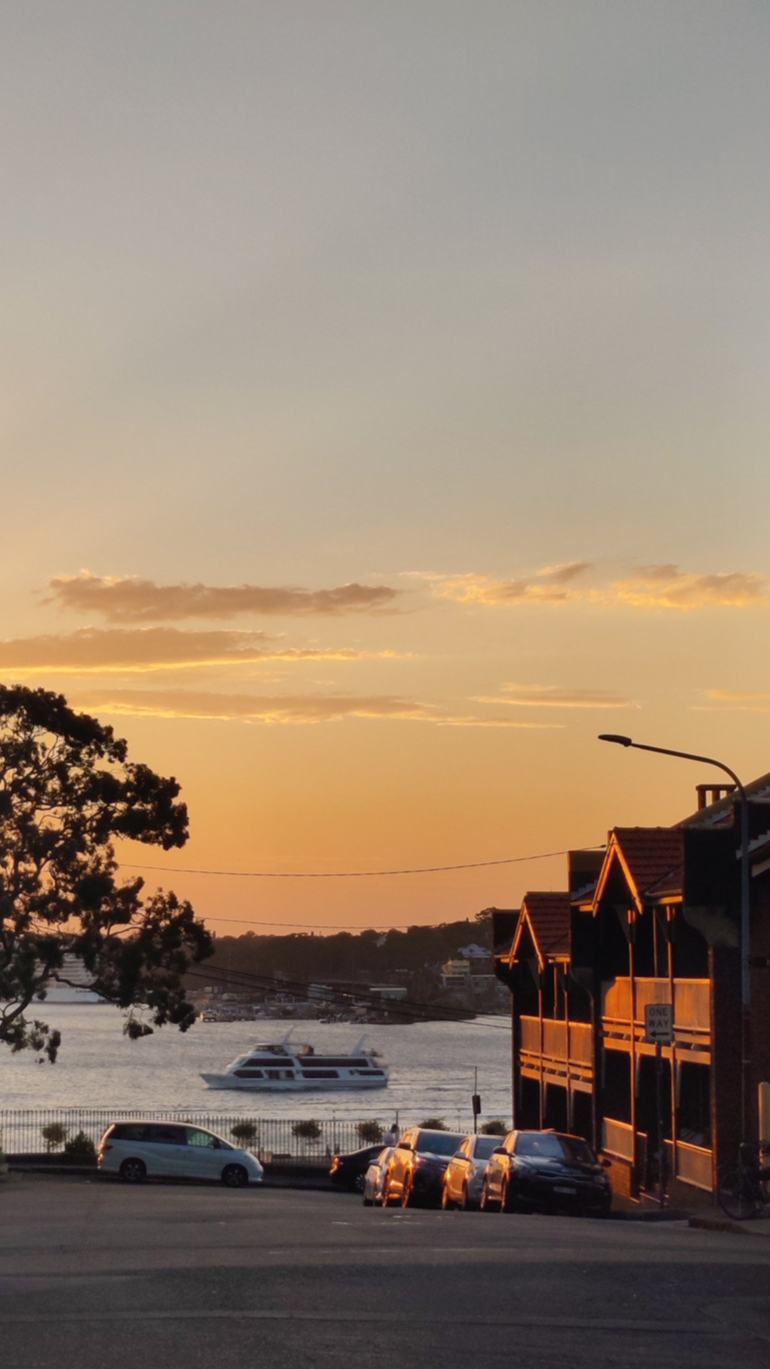 City balconies by water at sunset